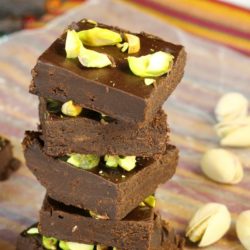 A stack of 5 Minute Dark Chocolate Fudge with pistachios and nuts.