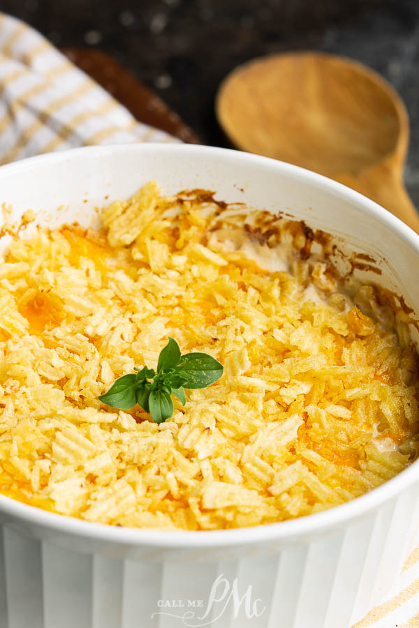Creamy cheesy corn casserole in a white dish.