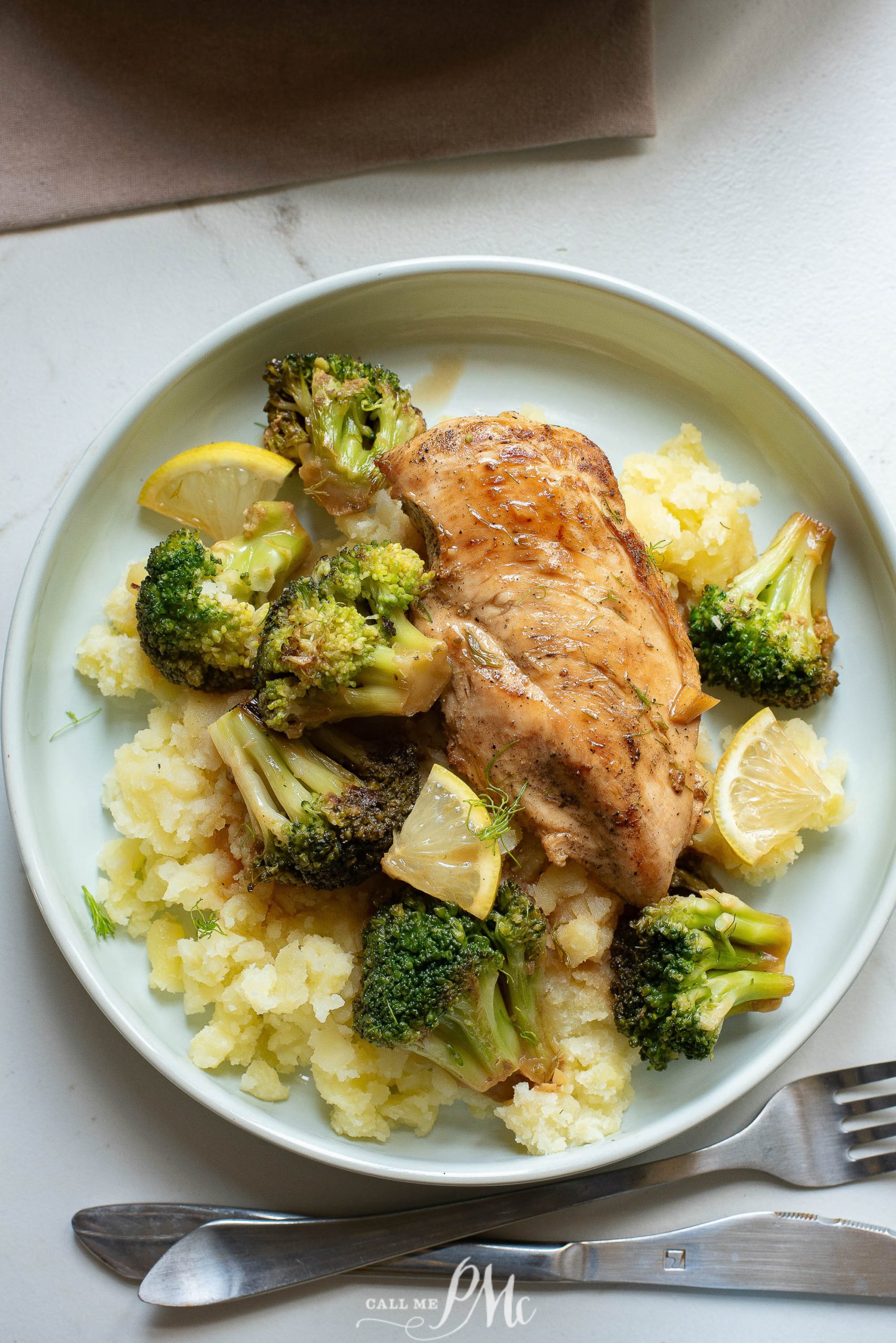 Grilled chicken breast served with broccoli and mashed potatoes on a plate.