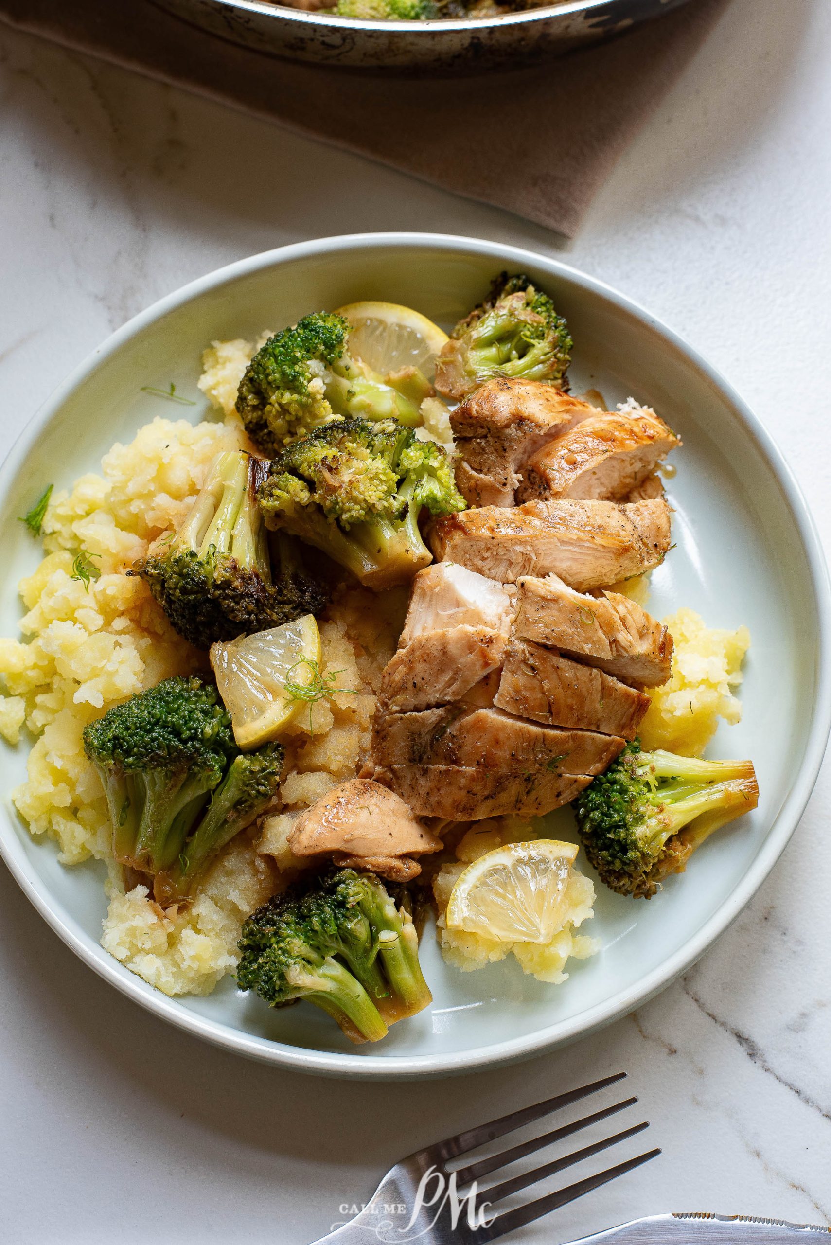 Grilled chicken breast slices with broccoli and mashed cauliflower on a plate.