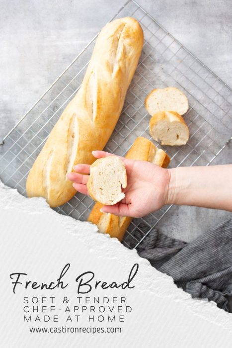 A hand holds a slice of French bread above a cooling rack with a baguette and more slices. Text reads: "French Bread: Soft & Tender, Chef-Approved, Made at Home" and "www.castironrecipes.com." Just like an authentic French baguette!