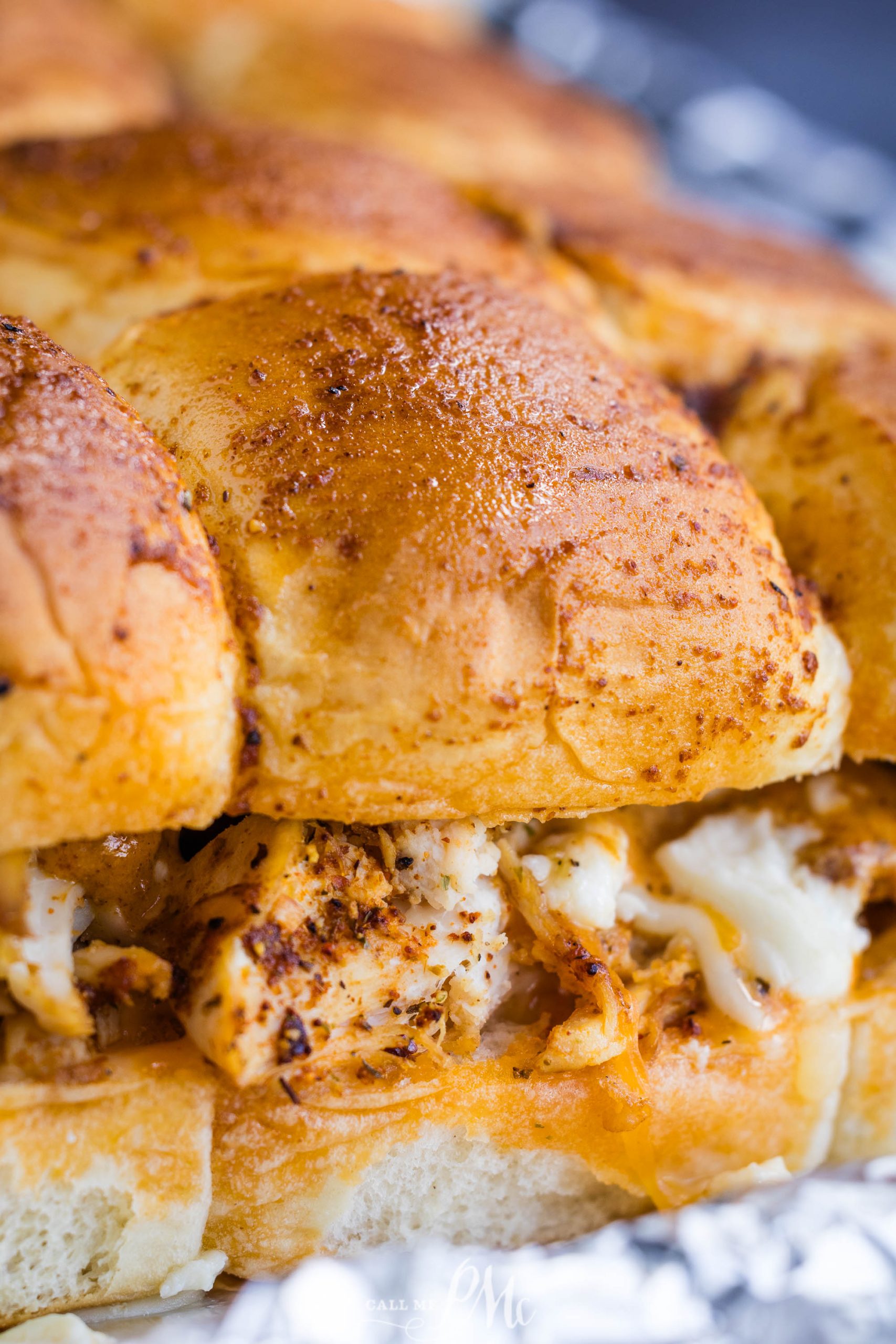 Close-up of a baked chicken and cheese sandwich with a golden-brown crust.