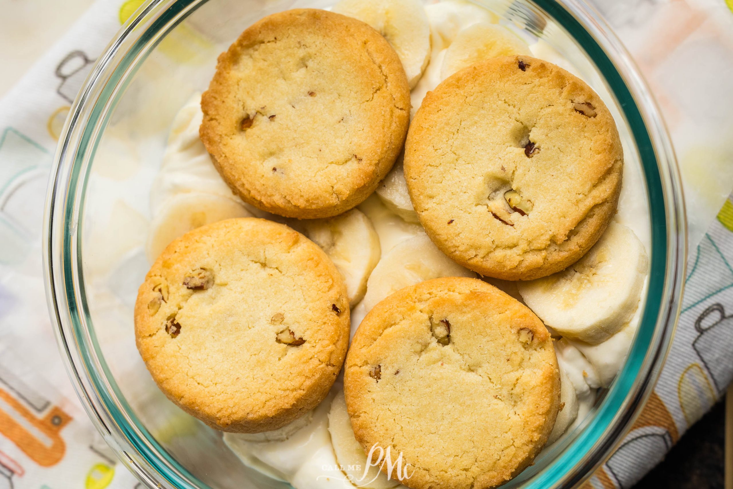 A glass bowl containing Pecan Sandies Banana Pudding.