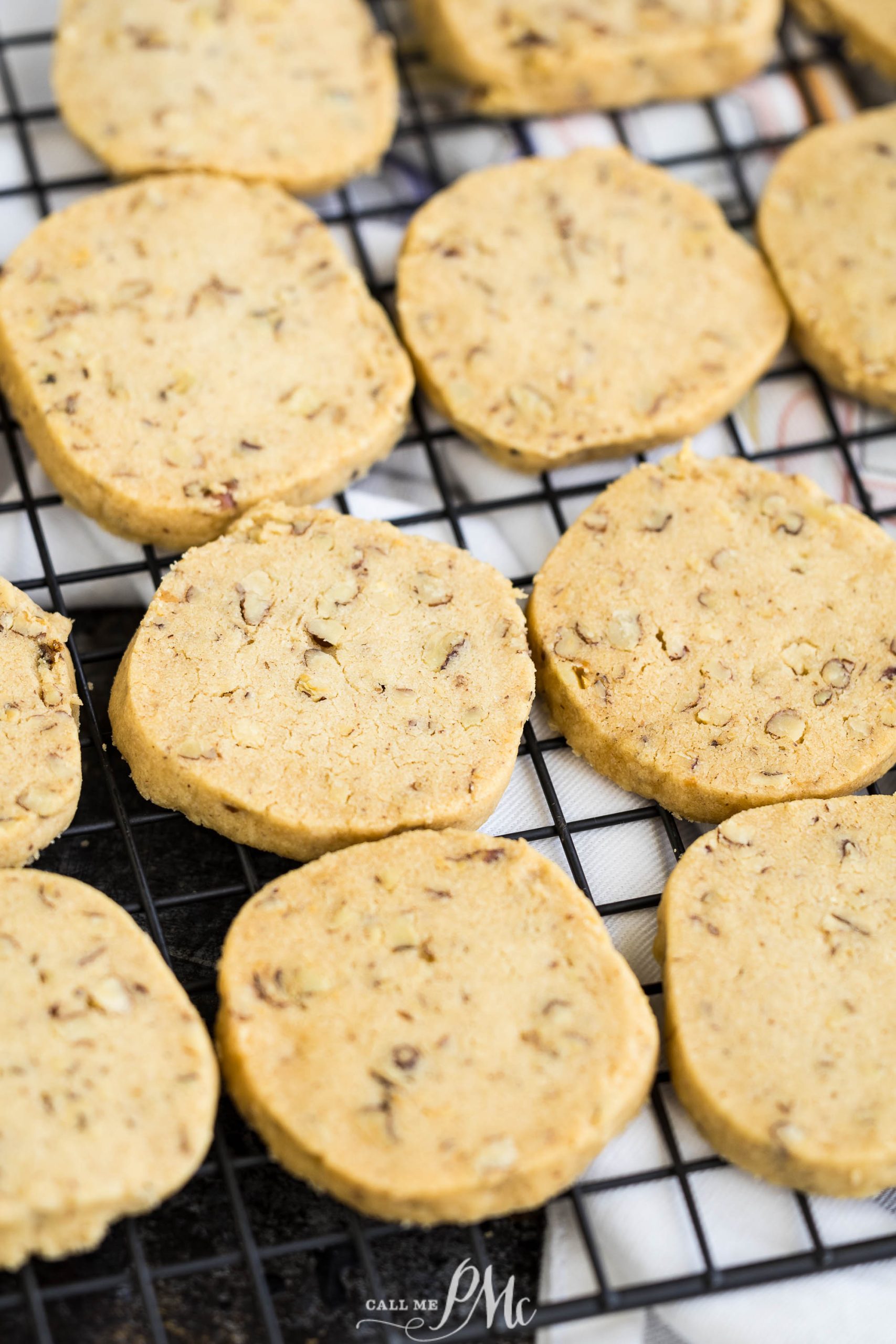 Pecan Sandies Recipecooling on a black wire rack.