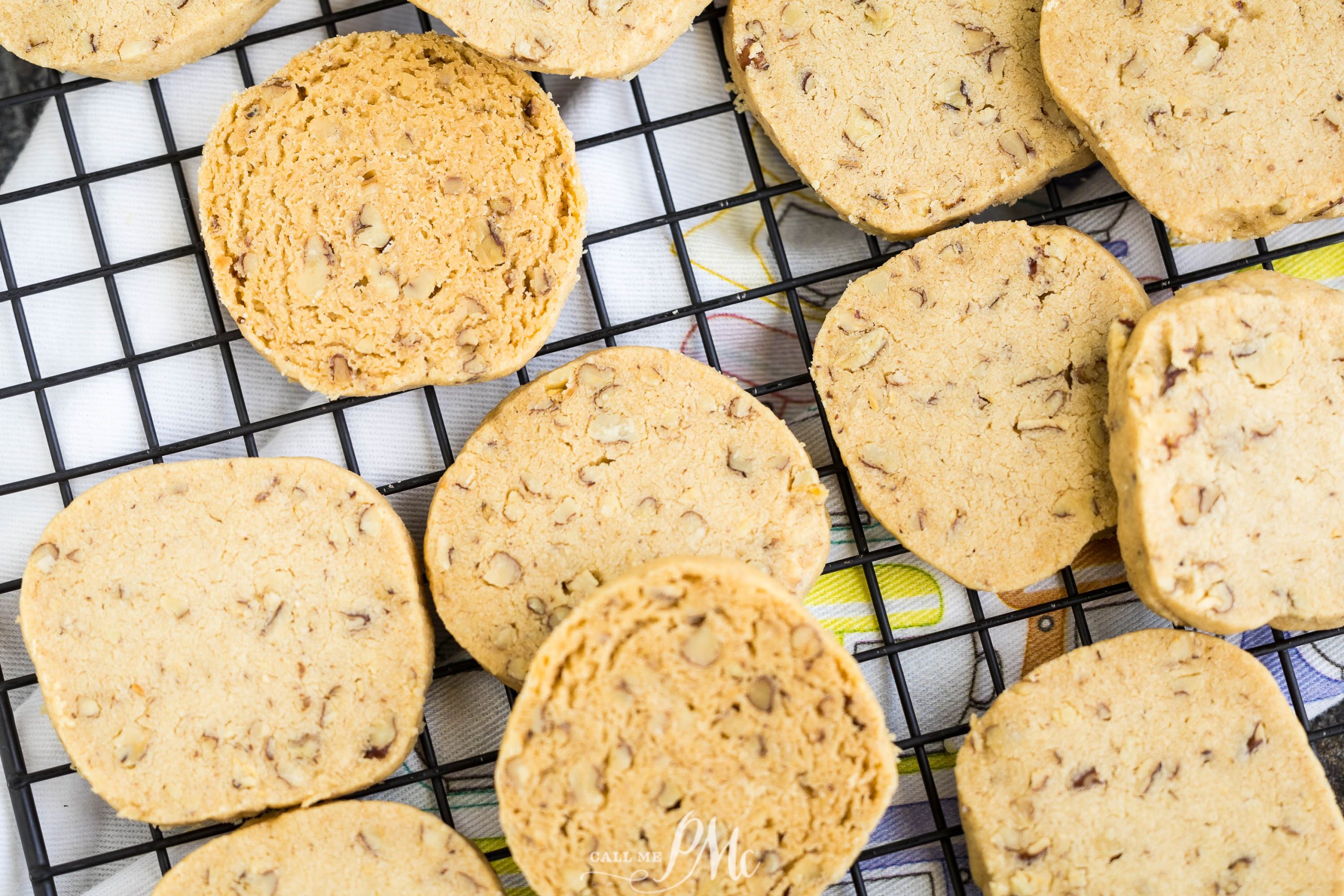 Pecan Sandies Recipe cooling on a black wire rack.