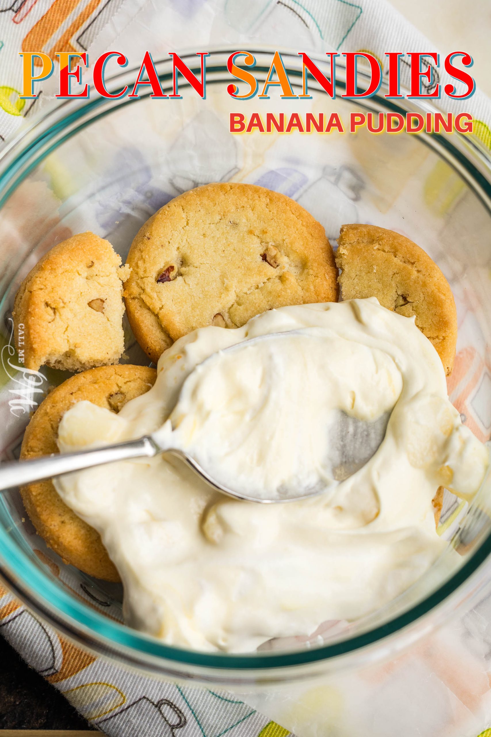 A bowl containing pecan sandies cookies partially covered with banana pudding and a spoon placed on top. The text "Pecan Sandies Banana Pudding" is written on the image.