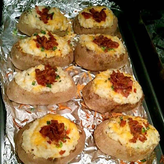 Twice stuffed baked potatoes on a tray.