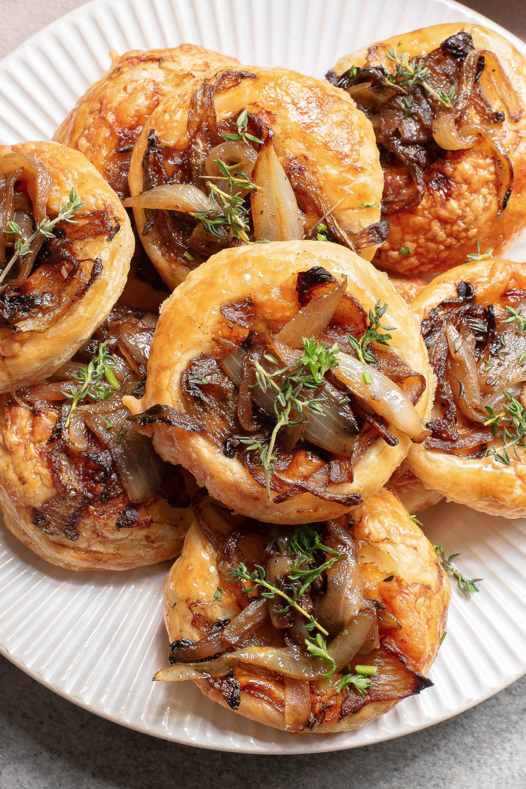 A plate of puff pastry garnished with fresh thyme.