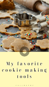 Cookie dough cut in shapes with metal cutters, sprinkles, and a rolling pin on a floured surface. Text reads "My favorite cookie baking tools.