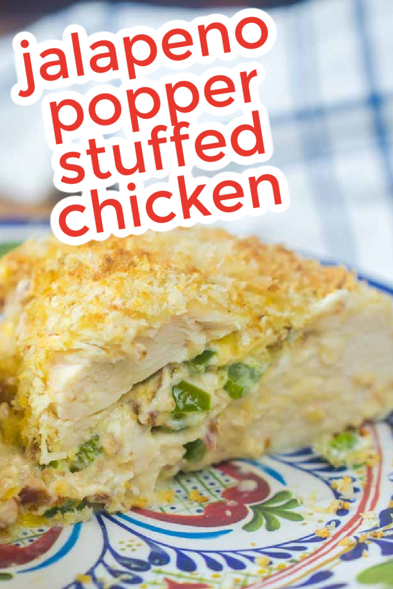 Close-up of Jalapeno Popper Stuffed Chicken on a decorative plate. The chicken is perfectly sliced to reveal the rich, cheesy filling bursting with spicy jalapenos. Text overlay reads, "Jalapeno Popper Stuffed Chicken.