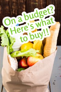 Paper bag with lettuce, apples, baguette, a carton of milk, and assorted vegetables. Text overlay reads, "On a budget? Here's what to buy!!.